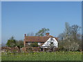 Newhouse Farm Cottage seen across a field