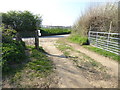 Track across field arrives at corner on Plummerden Lane