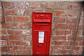 View of an old Queen Victoria postbox on the wall at Epping station