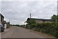 Barns on each side of the road at Parsonage Farm