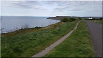 TA0684 : Path next to road on cliff top at Osgodby Hill by Clive Nicholson