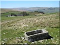 SD9487 : Stone trough on the hillside by Gordon Hatton
