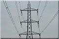 Looking up at a pylon from a path next to the A406