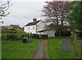 Path from churchyard passing a white house