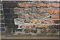 Old benchmark on wall of Nedham Street railway bridge