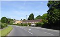 A terrace of modern houses and an older, thatched house, Froxfield