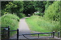 Walkers on canal side path approaching Ruskin Avenue