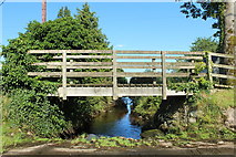 NX9759 : Footbridge over the Kirkbean Burn by Billy McCrorie