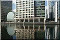 View of buildings in Canary Wharf reflected in the water in South Dock