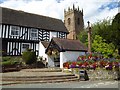 The Vicarage, lychgate, church tower and cross in Claverley