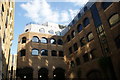 View of apartments behind the remains of Winchester Palace from Clink Street