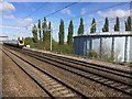 View from a Reading-Swindon train - Cross-Country train passing a storage tank at Didcot