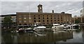 View of The Ivory House and boats reflected in St. Katharine Docks