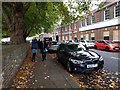 Cars parked along Strand On The Green, looking west