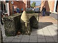 Concrete bee hive on a concrete tree stump