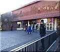 Woman in blue coat leaves the Potteries Museum and Art Gallery