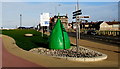SH9980 : Green buoy and a signpost, West Parade, Rhyl by Jaggery