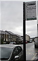 Welsh side of a bus stop sign, Bute Street, Treherbert