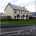 Row of three recently-built houses alongside the A478, Pentlepoir