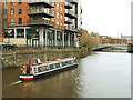 Canal boat on the river Aire above Leeds Bridge