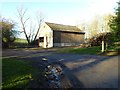 A barn and timber stacks