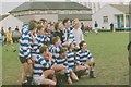 University football team celebrating by the pavilion