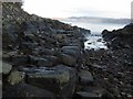NM6578 : Ultimate rocks of Port Aird an Iasgaich seen from the jetty in the geo by ian shiell