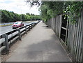 Hole in a wooden fence alongside the  Southern Distributor Road, Newport