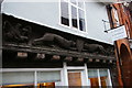 Thoroughfare, Halesworth: carving on shop-front