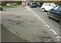 A structural failure in the road surface at the junction of  B3233 with Elmfield Road