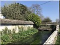 Thatched wall, river and bridge