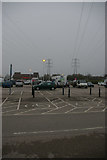 TM1242 : Pylon lines crossing superstore car-park, Copdock by Christopher Hilton