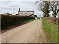 View North-Westwards along Moneycarragh Road towards house being reroofed