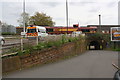 Ambulance waits for car train at Barkers Butts Lane level crossing