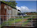 Gate and barn, and a pile of rubbish