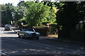 View of a Rolls Royce Corniche Convertible passing along Court Road