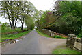 Scotsburn Road passing the entrance to Newmore Mains Farmhouse