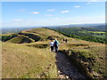 SO7539 : Walkers descending Herefordshire Beacon by Jeff Gogarty