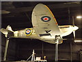 View of a Spitfire suspended from the ceiling in Hangar 1 in the RAF Museum