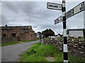 Road signs and barn conversion in Ousby