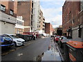 Wheelie bins, cars and puddles, Crockherbtown Lane, Cardiff city centre