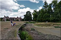TL8647 : Long Melford, Kentwell Hall: The dried up pond by Michael Garlick