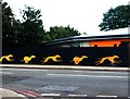 View of greyhound murals on the wall of the railway bridge over Catford Bridge station