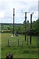 Communications mast and electricity poles