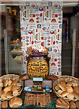 NH5458 : A window display at William Deas, Baker, Dingwall by Walter Baxter