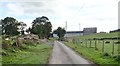 Rock outcrop and farm outbuildings on either side of Coolderry Road