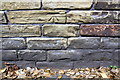 Benchmark on wall on north side of Atlas Mill Road