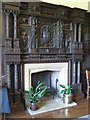 Carved panels around the fireplace in the Blayney room at Gregynog