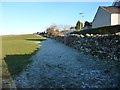 Thin snow in the shadow of a wall, Langwathby