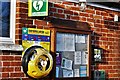 Great Bricett: Defibrillator and notice board on the wall of the community hall